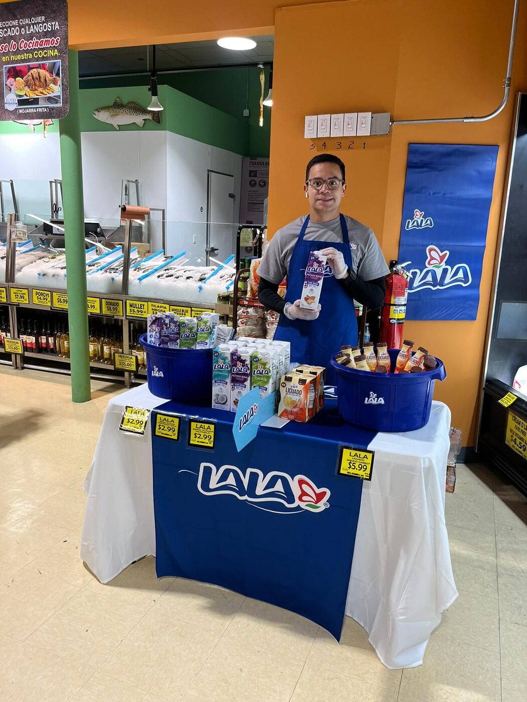 Clip brand ambassador sampling Lala dairy products at a supermarket display
